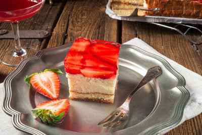 Layered dessert with strawberries and made with gelatine on a silver plate